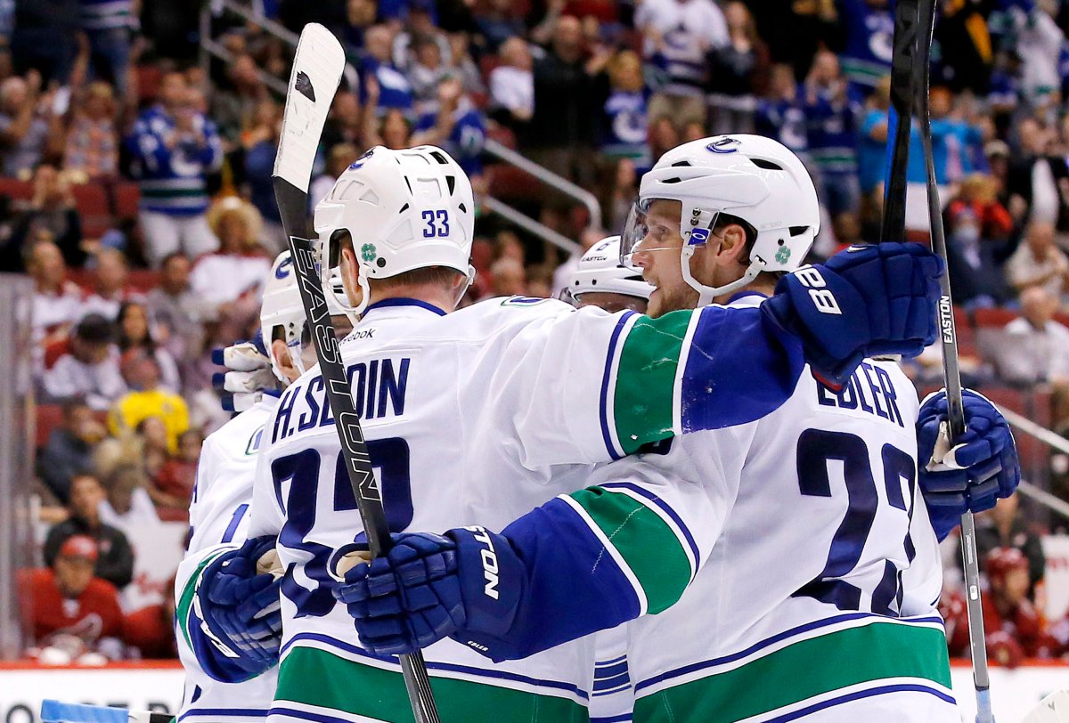 Vancouver Canucks' Alexander Edler celebrates his goal against the Arizona Coyotes with teammates during the third period. The Canucks defeated the Coyotes 3-1.