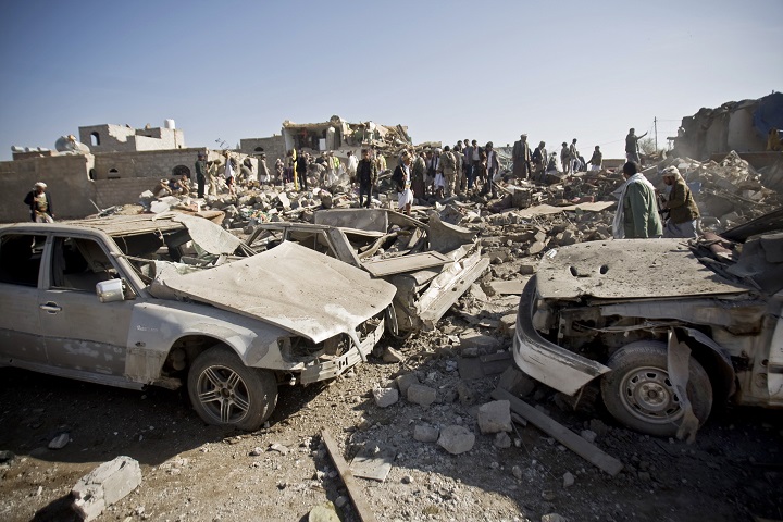 People search for survivors under the rubble of houses destroyed by Saudi airstrikes near Sanaa Airport, Yemen, Thursday, Mar. 26, 2015.