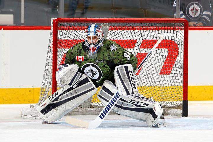 Goaltender Michael Hutchinson of the Winnipeg Jets takes part in the pre-game warmup in a special commemorative jersey for Canadian Armed Forces appreciation night on Wednesday at the MTS Centre.