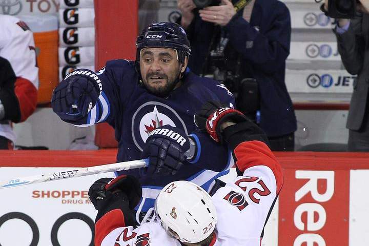 Dustin Byfuglien of the Winnipeg Jets takes down Erik Condra of the Ottawa Senators at the MTS Centre on Wednesday. He was hurt later in the game and is out for two to four weeks.