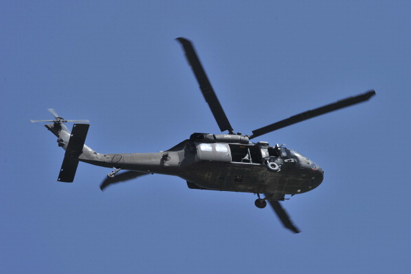 FILE: A UH-60 Black Hawk helicopter flies near the Spozhmai Hotel in Qargha lake in the outskirts of Kabul on June 22, 2012.