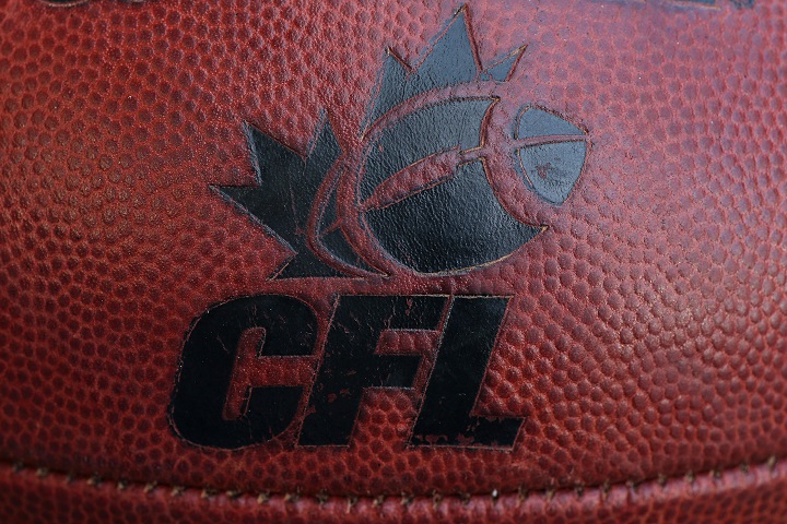 The CFL logo on an official Canadian CFL league ball during warm-ups before the Saskatchewan Roughriders CFL game against the Toronto Argonauts on July 11, 2013.