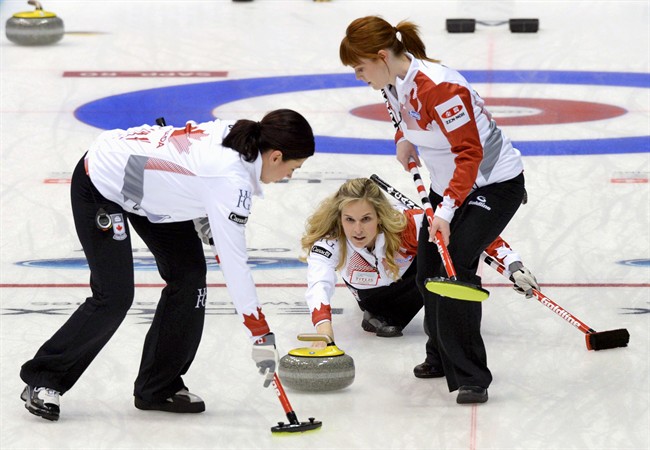 Canada skip Jennifer Jones, centre, releases the rock as the team plays Finland during the first end in the women's World Curling Championships in Sapporo, northern Japan, Saturday, March 14, 2015.
