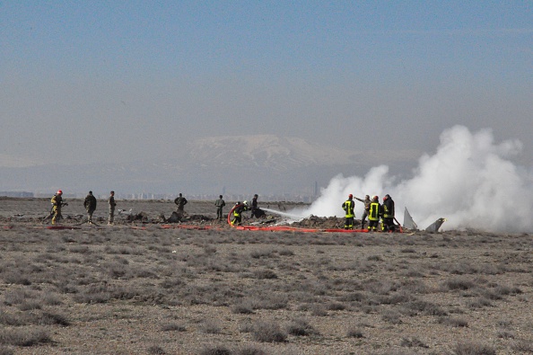 Firefighters extinguish a military aircraft after it fell down at Ortakonak neighborhood in Karatay district of Konya province, Turkey on March 05, 2015.