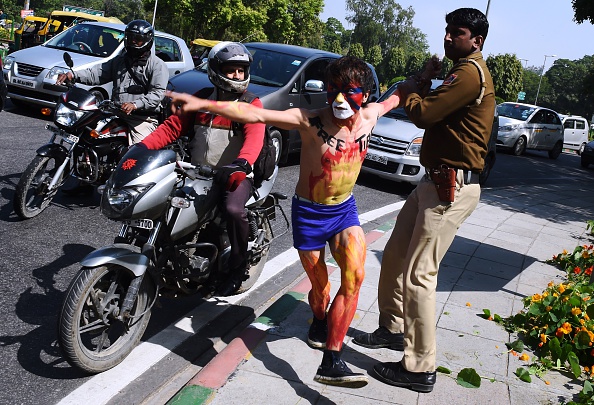 An Indian policeman detains a Tibetan exile during a protest outside the Chinese embassy in New Delhi on March 10, 2015. Scores of Tibetan protesters March 10 shouted independence slogans and waved anti-China banners in New Delhi to commemorate the anniversary of the 1959 uprising against Chinese rule. 