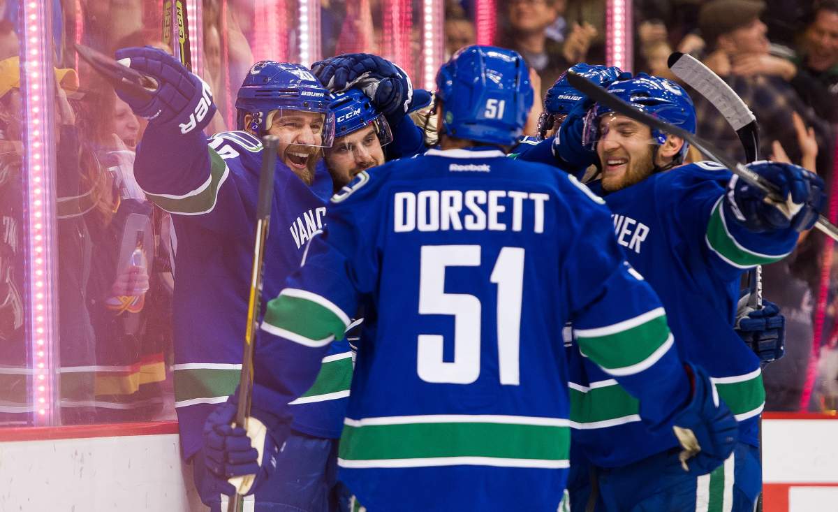 Chris Higgins #20 celebrates with teammates Derek Dorsett #51, Yannick Weber #6 and Brad Richardson #15 after scoring a goal against the Toronto Maple Leafs.