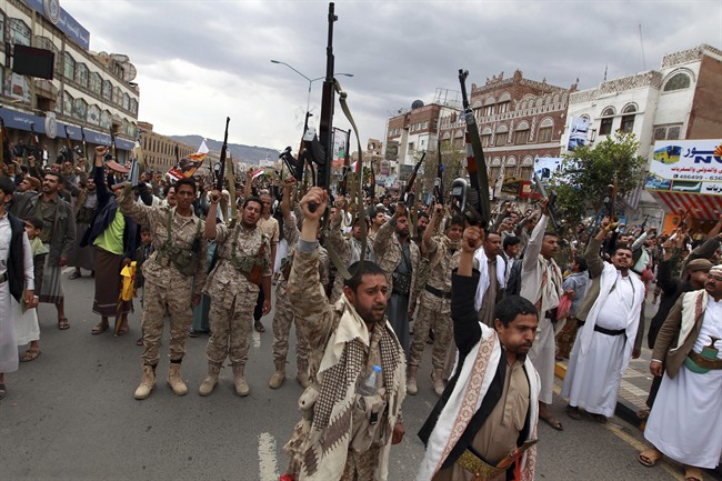 Shiite rebels, known as Houthis, hold up their weapons to protest against Saudi-led airstrikes during a rally in Sanaa, Yemen, Thursday, March 26, 2015. 