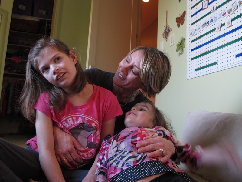 Alexis Carey, left, 10, sits with her mother Clare Carey, center, and her sister Alanis Carey, right, 5, on Friday, Feb. 27, 2015, in Boise, Idaho.