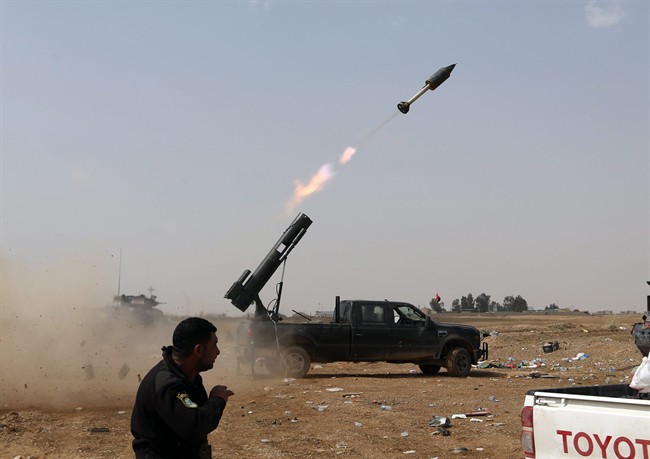 Iraqi security forces launch a rocket against Islamic State extremist positions during clashes in Tikrit, 130 kilometers north of Baghdad, Iraq, on March 30, 2015.