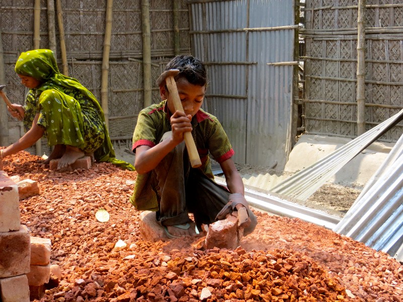 Bangladeshi boy making bricks.