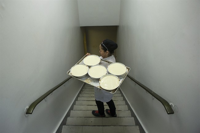 A tray of dessert dishes is carried at Modern Kosher Catering at Toronto's Adath Israel synagogue on Wednesday, March 25, 2015.