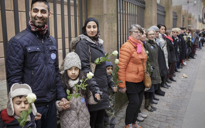 Danish people of Muslim, Jewish and Christian faith form a peace ring around the synagogue in Copenhagen, Saturday, March 14, 2015.