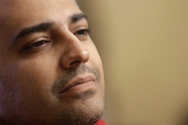 Canadian Al-Jazeera journalist Mohamed Fahmy listens during an interview with The Associated Press in Cairo, Egypt on Feb. 19, 2015.