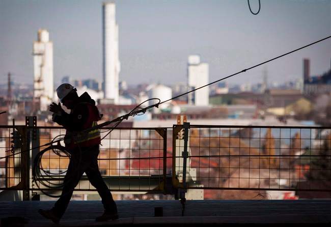 A worker walks on a construction site in Hamilton, Ont., on November 14, 2013. 
