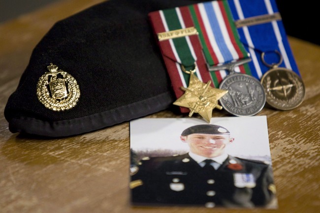 A photo of Cpl. Stuart Langridge is seen along with his beret and medals at a news conference on Parliament Hill in Ottawa, Thursday October 28, 2010. 