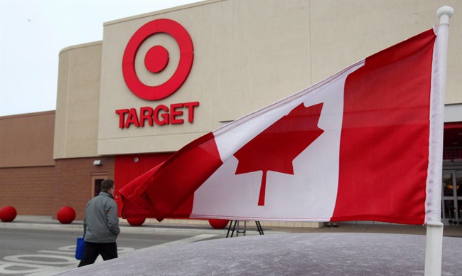 A Canadian flag flies on the car of a customer's car parked in front of a Target store in in Guelph, Ont.