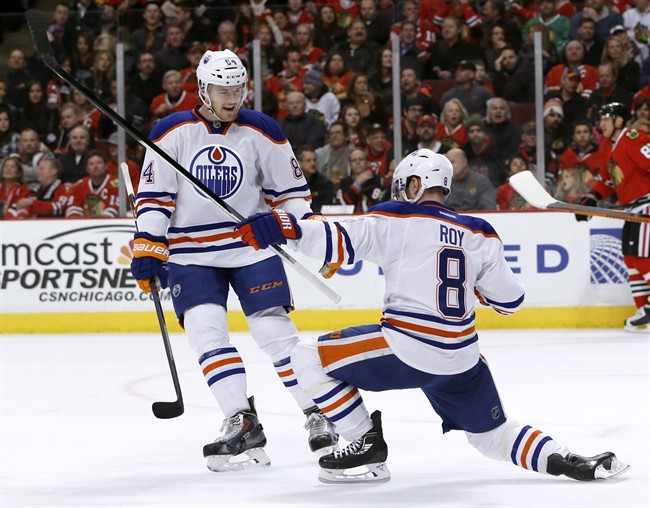 Edmonton Oilers center Derek Roy (8) celebrate his goal with defenseman Oscar Klefbom (84) during the first period of an NHL hockey game against the Chicago Blackhawks, Friday, March 6, 2015, in Chicago. 