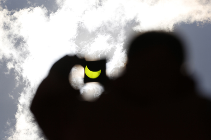 A solar eclipse is seen through a dark glass plate in Sarajevo, Bosnia, on Friday, March 20, 2015.
