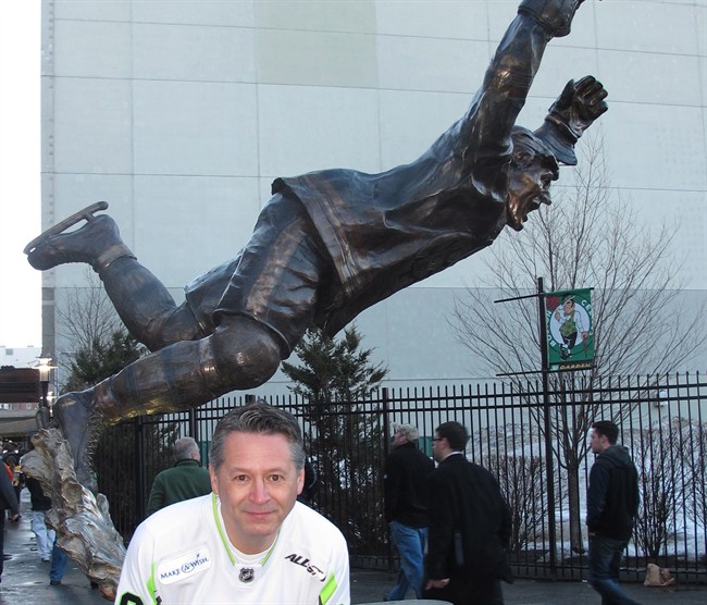Edmonton's Rob Suggitt is shown by the Bobby Orr statue in Boston in a recent handout photo. Suggitt has just started a 30 games in 30 nights road trip to all the NHL arenas.