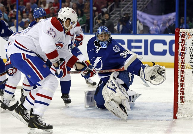Tampa Bay Lightning goalie Ben Bishop makes a save on Montreal Canadiens' Alex Galchenyuk during the first period of an NHL hockey game Monday, March 16, 2015, in Tampa, Fla.