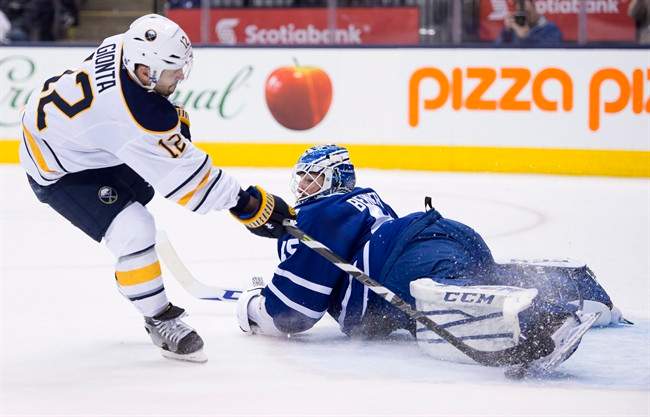 Toronto Maple Leafs goaltender Jonathan Bernier makes a save on Buffalo Sabres Brian Gionta in overtime shootout NHL action in Toronto on Wednesday March 11, 2015.