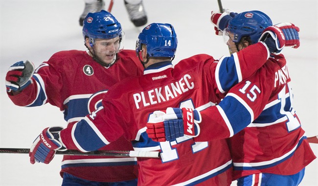 Montreal Canadiens' Tomas Plekanec celebrates with teammates Alex Galchenyuk, left and Pierre-Alexandre Parenteau, right, after scoring on the San Jose Sharks during first period NHL hockey action in Montreal,.