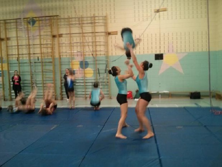 Promising gymnasts practice their routine.