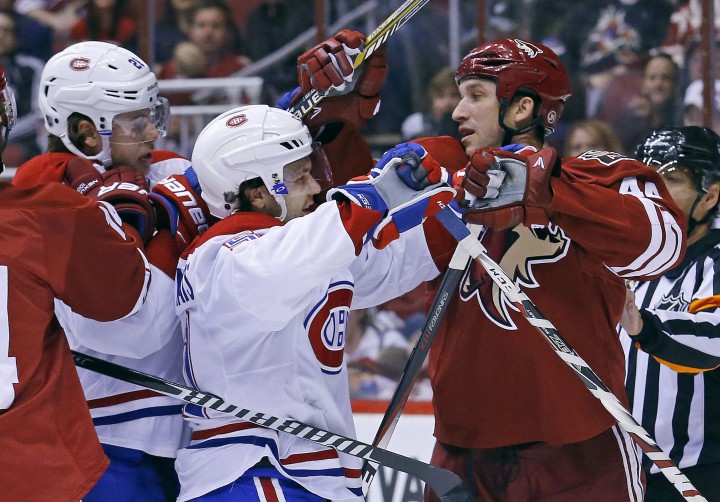 Montreal Canadiens center David Desharnais (51) and Arizona Coyotes right wing B.J. Crombeen (44), right, get physical during the second period of an NHL hockey game Saturday, March 7, 2015, in Glendale, Ariz.