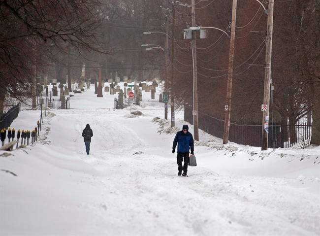 Pedestrians walk on the street in Halifax on Sunday, March 15, 2015.