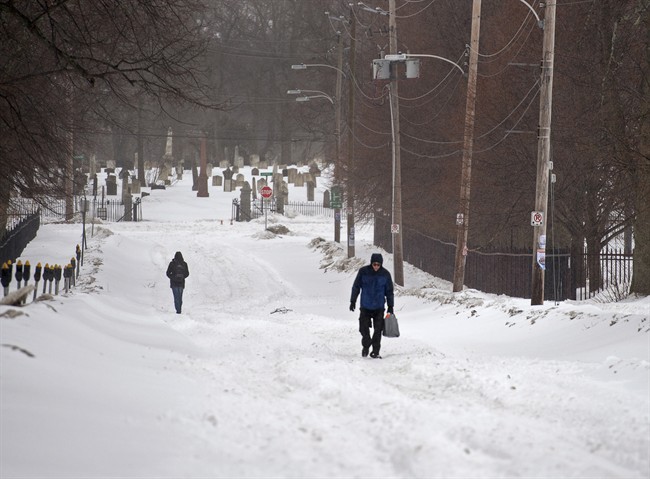 Pedestrians walk on the street in Halifax on Sunday, March 15, 2015.