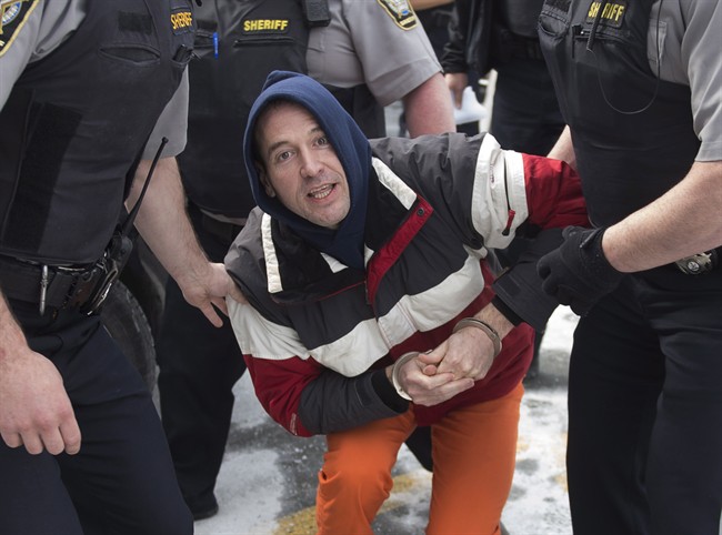 Christopher Phillips, accused of threatening police with a dangerous chemical, arrives for his bail hearing at provincial court in Dartmouth, N.S. on Tuesday, March 17, 2015. 