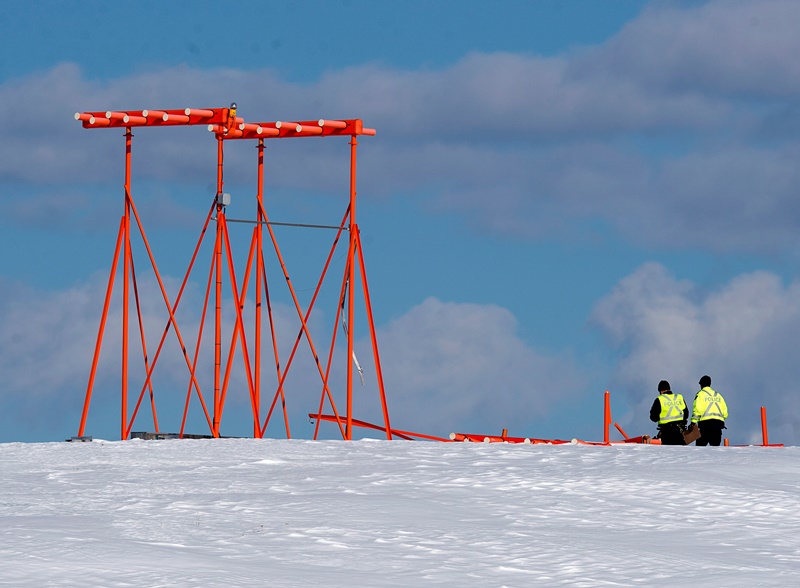 Investigators look at a structure believed to have been hit by Air Canada flight 1AC624 that crashed early Sunday morning during a snowstorm, at Stanfield International Airport in Halifax on Sunday, March 29, 2015. Air Canada says 25 people were taken to hospital.