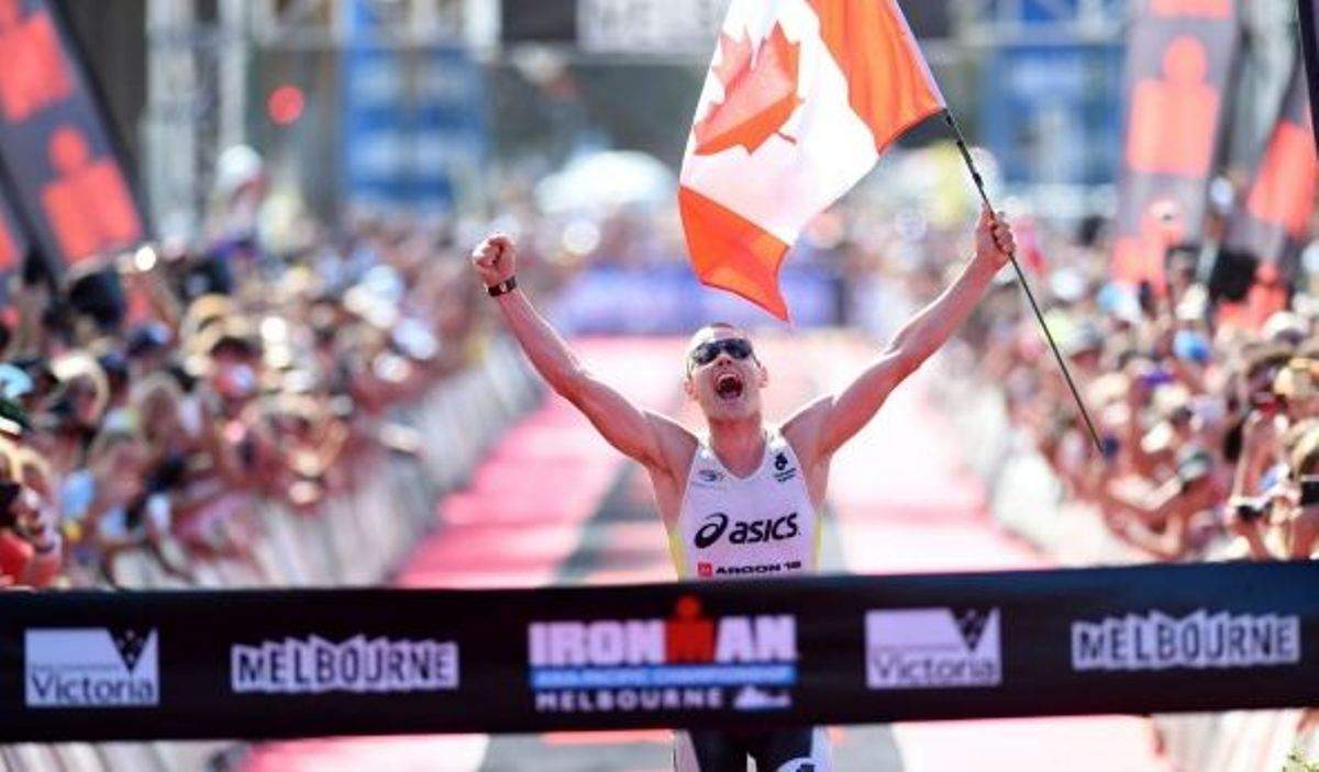 Jeff Symonds crossing the finish line at the Ironman Asia-Pacific Championship.