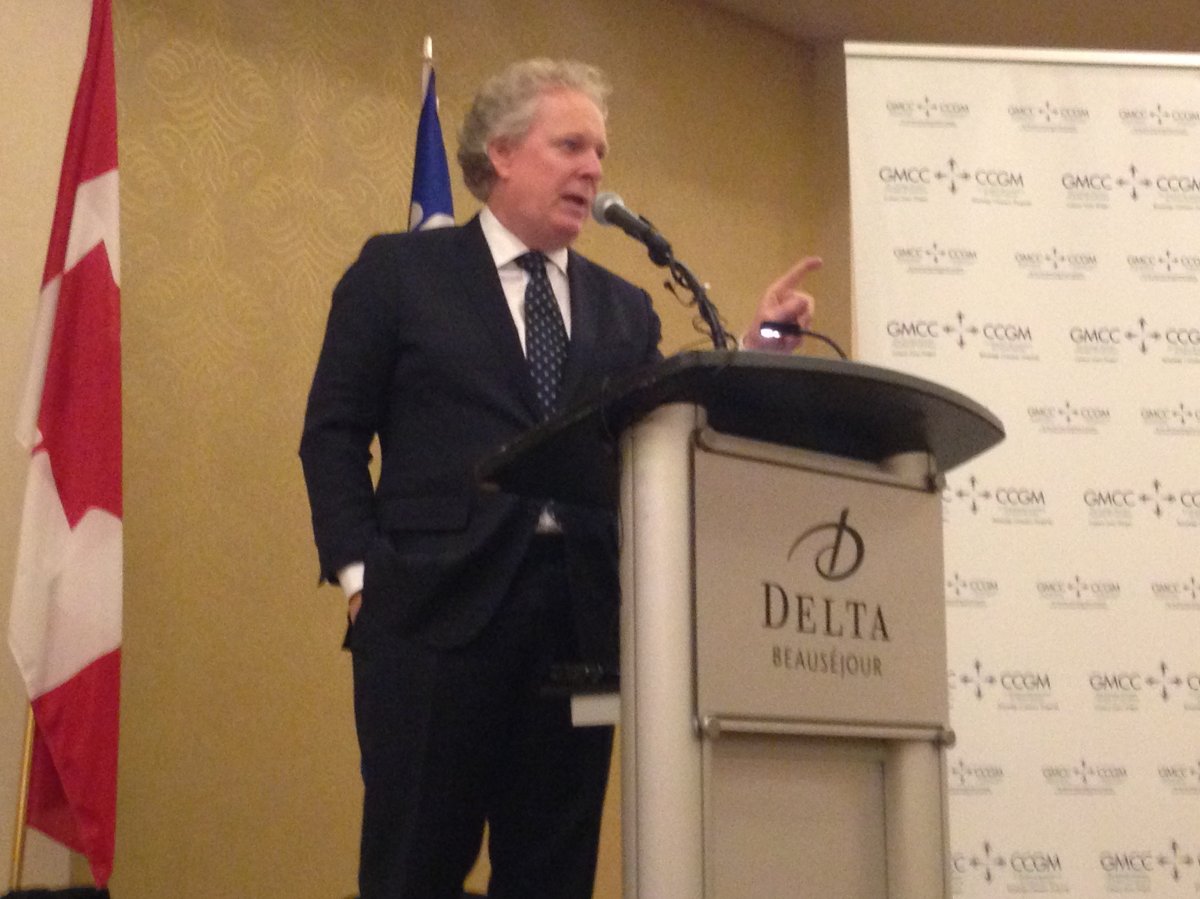 Former Quebec Premier Jean Charest addresses a room at the Delta Moncton on Monday.