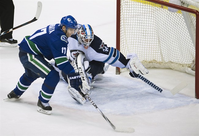 Vancouver Canucks' Radim Vrbata (17) gets his shot past Winnipeg Jets goalie Michael Hutchinson (34) during the second period of NHL action in Vancouver, B.C. Tuesday, March. 24, 2015.