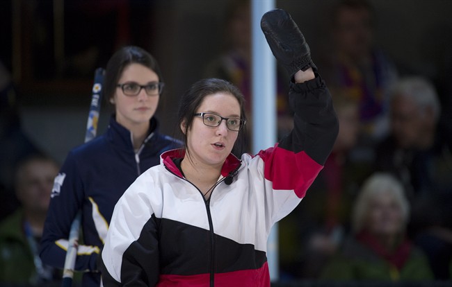 Nova Scotia fourth Mary Fay, left, looks over the shoulder of Ontario fourth Megan Smith as she calls a shot during the gold medal draw at the Canada Winter Games in Prince George, B.C. Saturday, Feb. 28, 2015. 