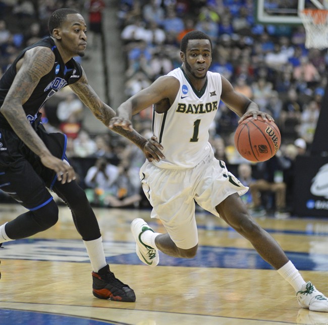 Baylor\’s Kenny Chery (1) drives around Georgia State\’s Kevin Ware, left, during the first half in the second round of the NCAA college basketball tournament, Thursday, March 19, 2015, in Jacksonville, Fla.