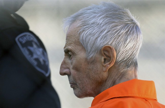 FILE - In this Tuesday, March 17, 2015, file photo, Robert Durst is escorted into Orleans Parish Prison after his arraignment in Orleans Parish Criminal District Court in New Orleans. 