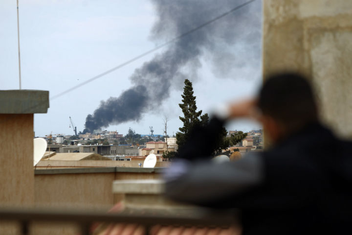 Smoke rises from the port of the eastern Libyan city of Benghazi on February 14, 2015 during clashes between forces loyal to the internationally recognised government and Islamist militias.  (File photo).