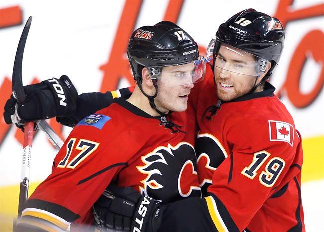 Calgary Flames' Lance Bouma, left, celebrates his game winning goal against the Colorado Avalanche with David Jones during third period NHL action in Calgary, Alta., Monday March 23, 2015. 