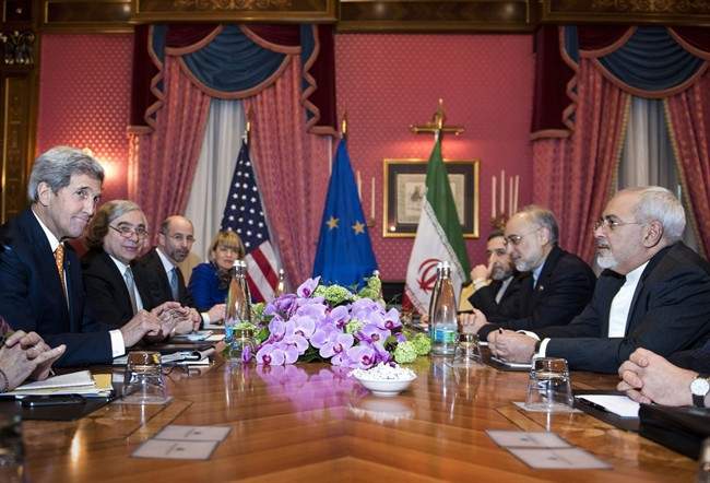 Iranian Foreign Minister Mohammad Javad Zarif (right) wait for the start of a meeting at a hotel in Lausanne Switzerland. 