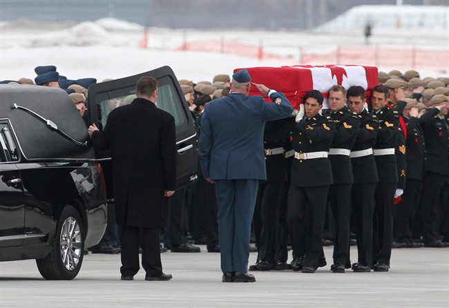 Military pallbearers from the Canadian Special Operations Forces Command carry the flag-draped casket of Sgt. Andrew Joseph Doiron at Canadian Forces Base Trenton in Trenton, Ont. on Tuesday March 10, 2015.