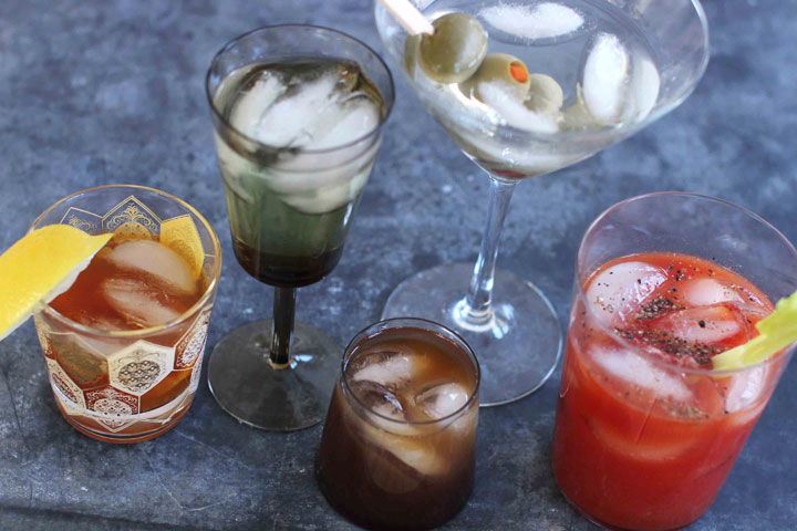 This March 23, 2015 photo shows mixed cocktails, from left, an old fashioned, a vodka gimlet, a Bull Shot, a dry martini and a bloody mary. "The culture of the cocktail really exploded in the '60s," says Maureen Petrosky, author of "The Cocktail Club." Suddenly there were cocktail dresses, new glassware, bar couture, Tiki drinks. The cocktail hour had its own wardrobe.