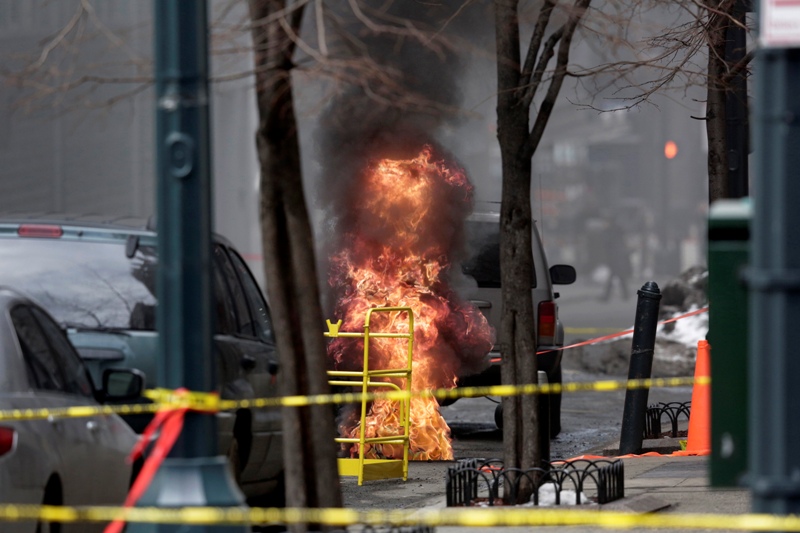 In this March 8, 2015 file photo, flames rise from a manhole in New York.