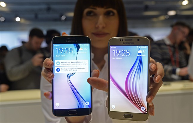 The new Galaxy S6, right, and S6 Edge are displayed during a Samsung Galaxy Unpacked 2015 event on the eve of this week’s Mobile World Congress wireless show in Barcelona, Spain, Sunday, March 1, 2015, unveiling a new phone that ditches its signature plastic design for metal and glass. The South Korean phone manufacturer also unveiled a premium model with a display that curves around the edges.