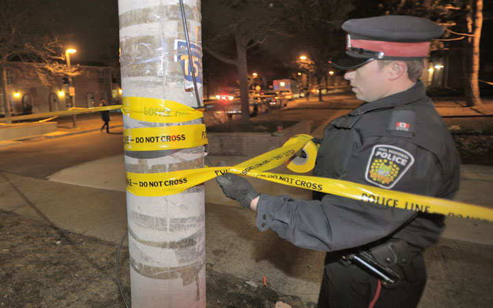 Police attend a scene of a shooting in Mississauga early Saturday March 21, 2015.