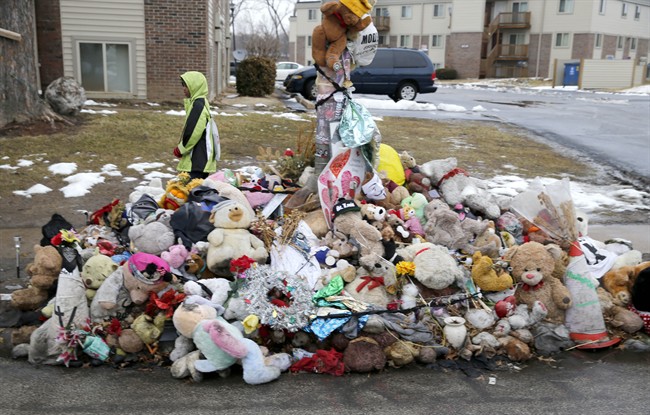 A boy walks past a memorial for Michael Brown, who was shot and killed by Ferguson, Mo., Police Officer Darren Wilson last summer, Tuesday, March 3, 2015, in Ferguson, Mo.