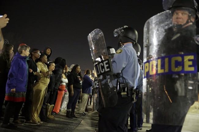 Police and protesters square off outside the Ferguson Police Department, Wednesday, March 11, 2015, in Ferguson, Mo.