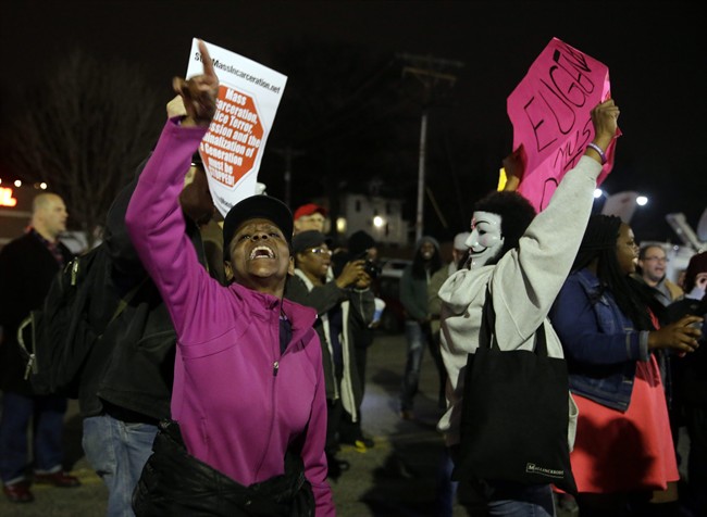 People demonstrate across the street from the Ferguson Police Department, Thursday, March 12, 2015, in Ferguson, Mo. 