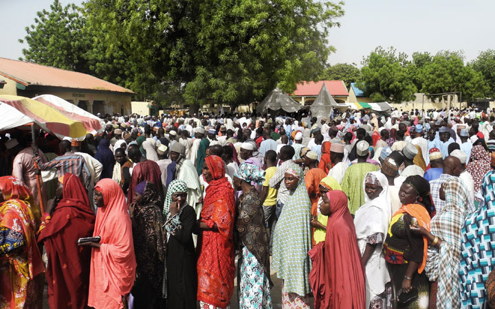 Voters from an Internally Displaced People (IDP) camp in Maiduguri queue to get registered for Nigeria's presidential elections in Maiduguri on March 28, 2015. Polling stations opened in Nigeria today.